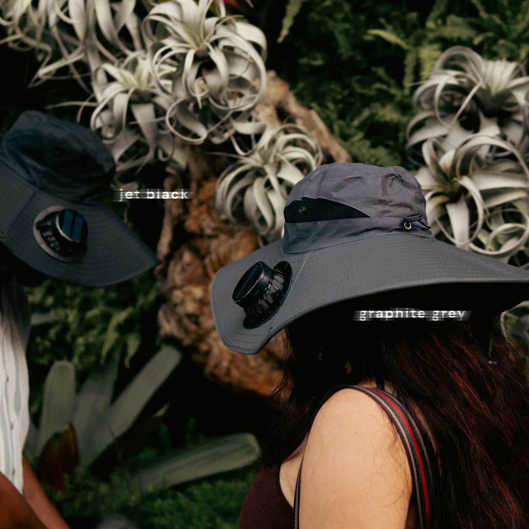 Couple wearing FannyCap solar fan hats in Jet Black and Graphite Grey during outdoor adventure