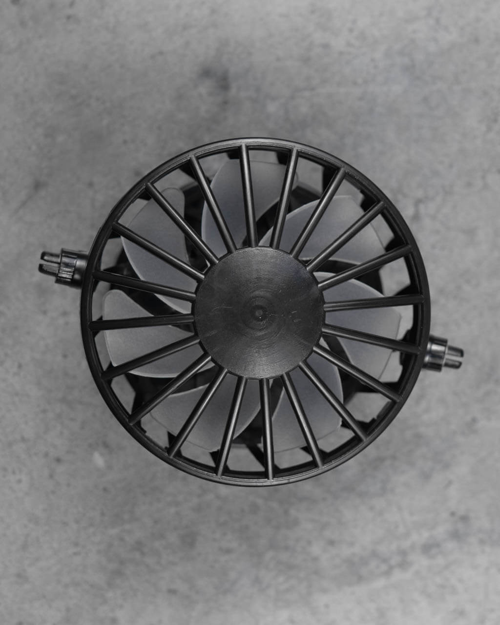 Close-up of FannyCap replacement fan underside showing black cage design and fan blades