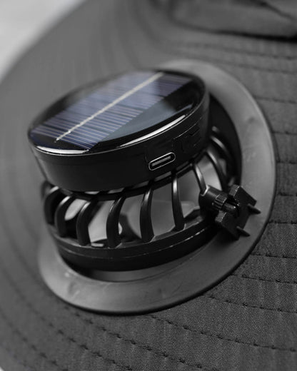 Detachable solar-powered fan for FannyCap hat showing USB-C port and airflow grill