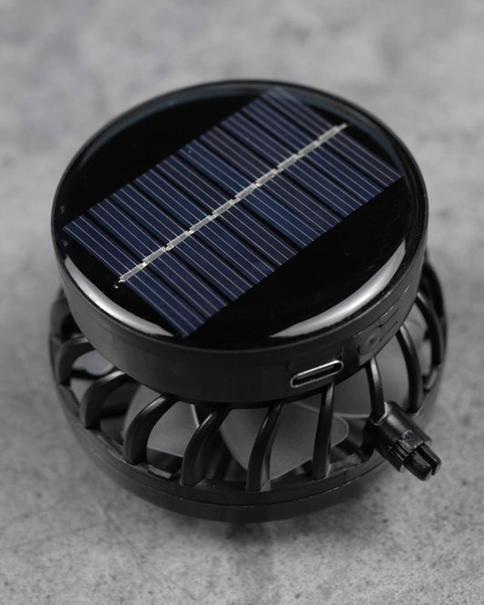 Top view of FannyCap solar fan module with blue solar panel and curved black housing