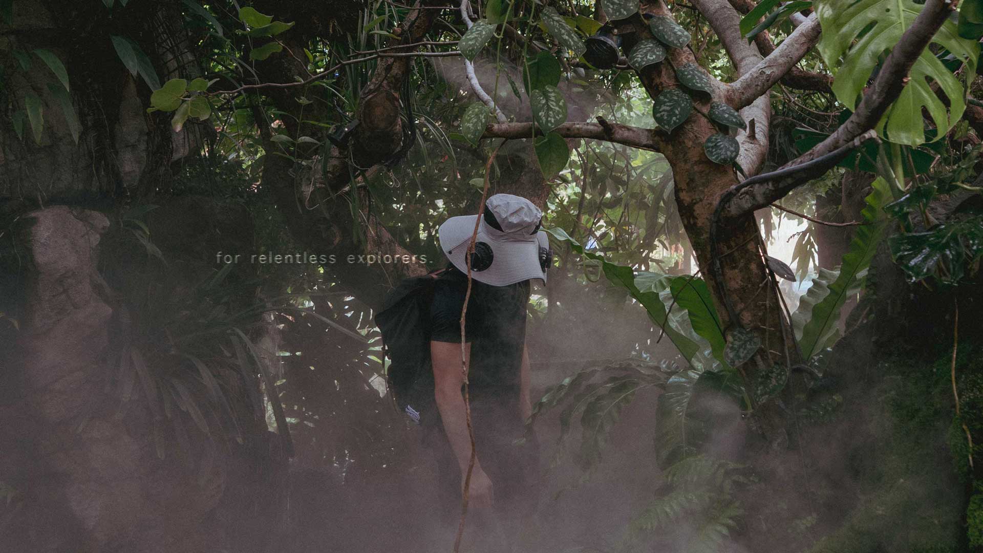 Person wearing FannyCap solar fan cooling hat in dense jungle environment, showcasing the hat’s outdoor, adventure-ready design